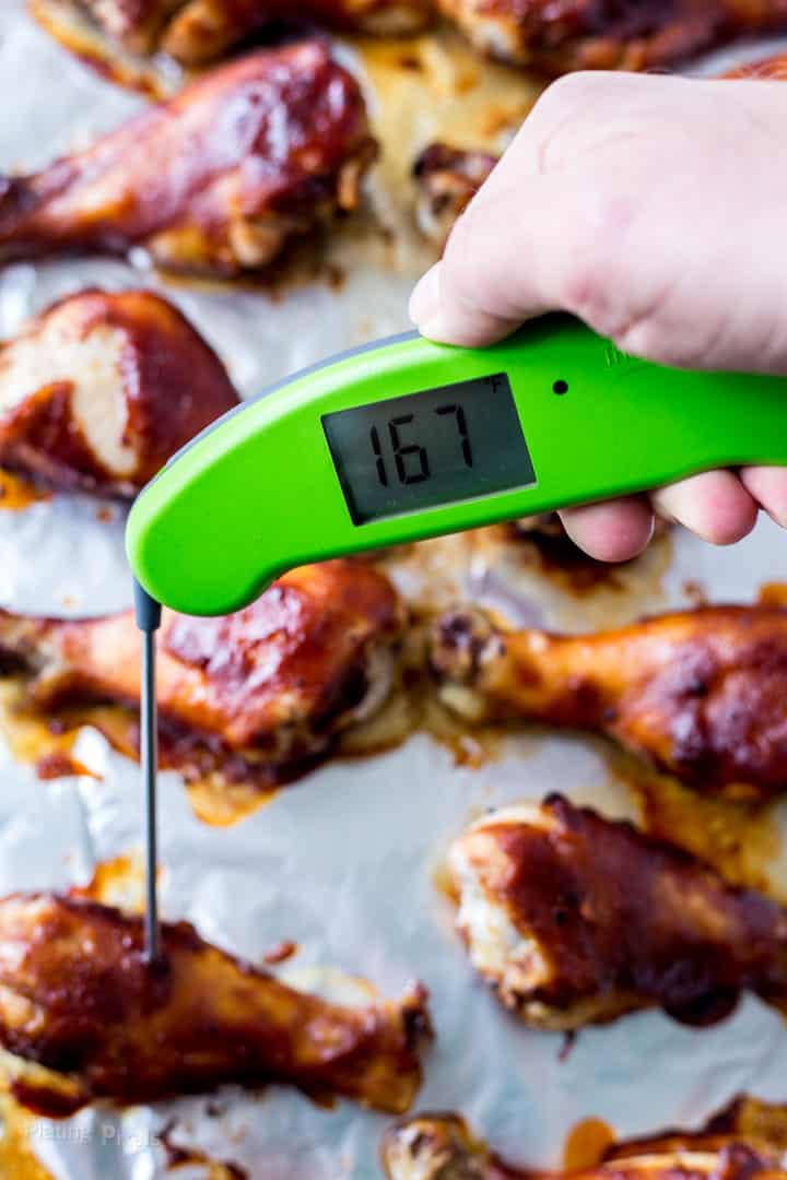 Checking internal temp of Baked Chicken Drumsticks with a digital thermometer