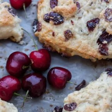 Close up of white chocolate cranberry scones on a baking sheet