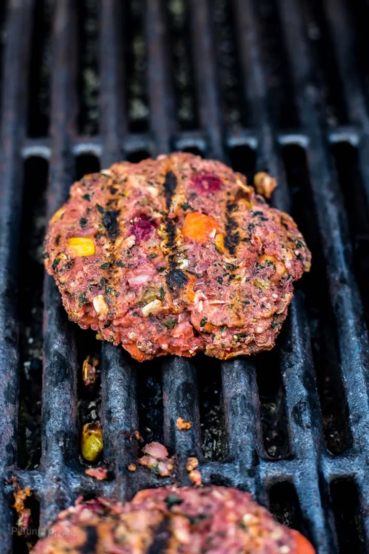 Close up of a veggie burger cooking on gril