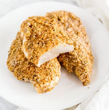 Three baked Keto Breaded Chicken Breasts on a plate