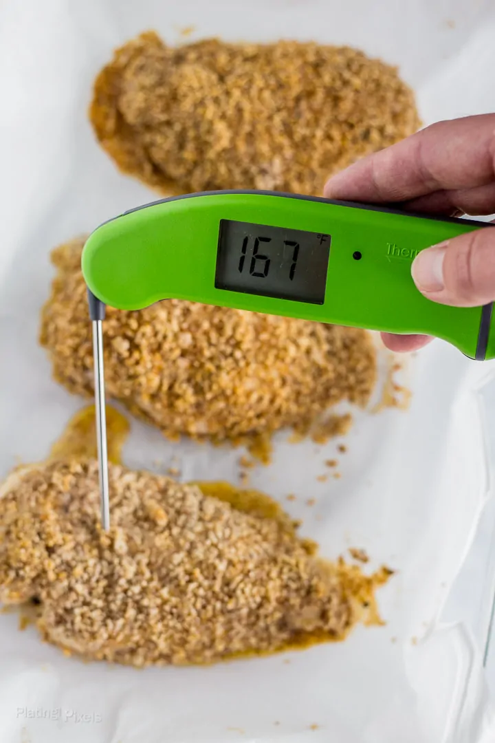 Checking safe internal temp of Baked Breaded Chicken Breast with a digital thermometer