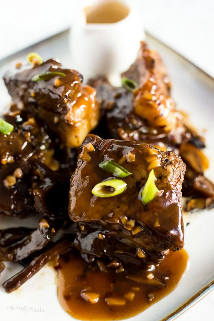 Slow Cooker Short Ribs on a plate smothered with Korean sauce