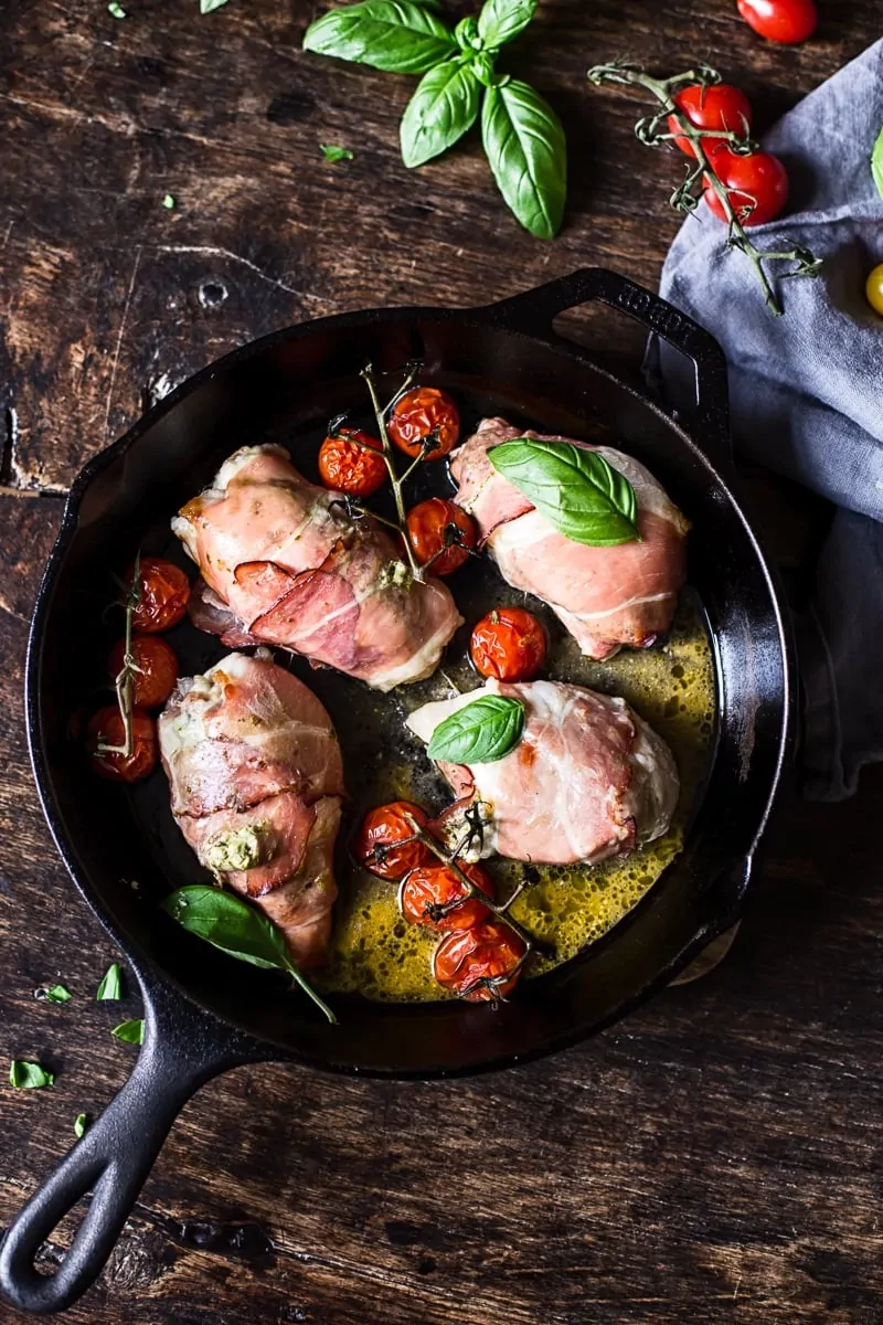 Prosciutto Wrapped Creamy Pesto Chicken Parcels baked in a skillet