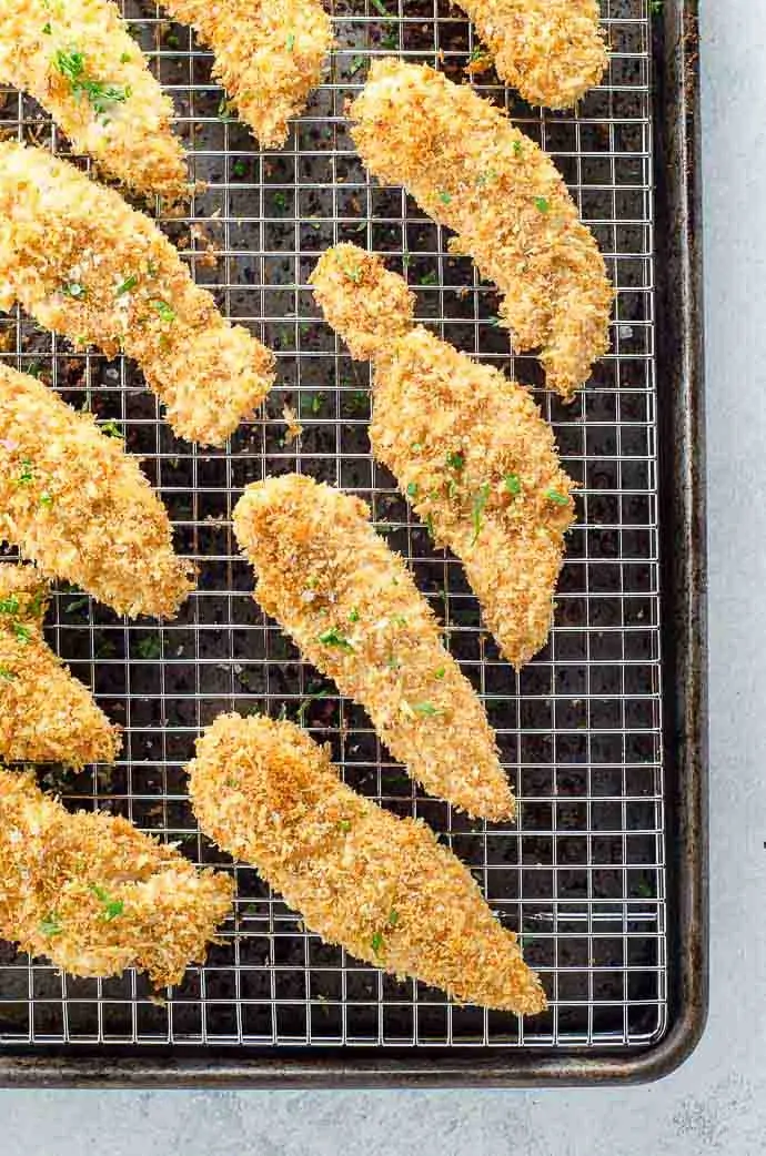Crispy Baked Chicken Tenders with Parmesan and Garlic on a cooling rack