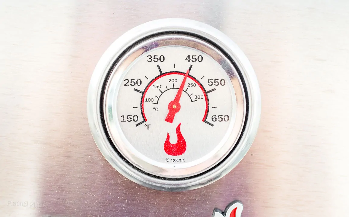 Temperature gage on a pre-heated gas grill showing 450 degrees