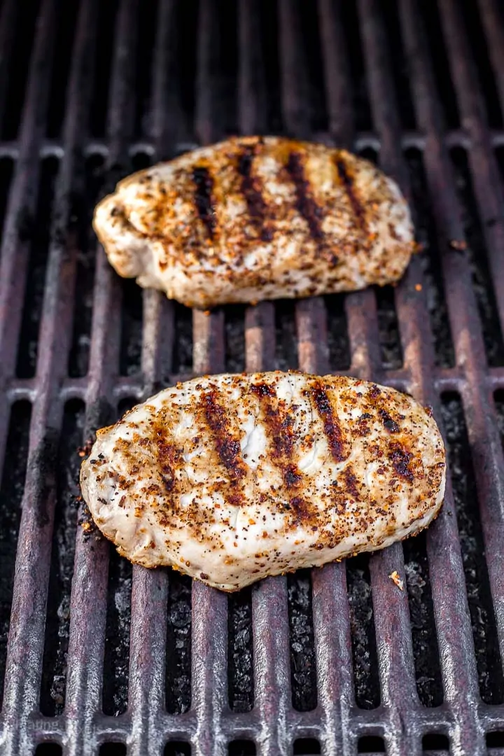 Two boneless in pork chops on grill with sear marks