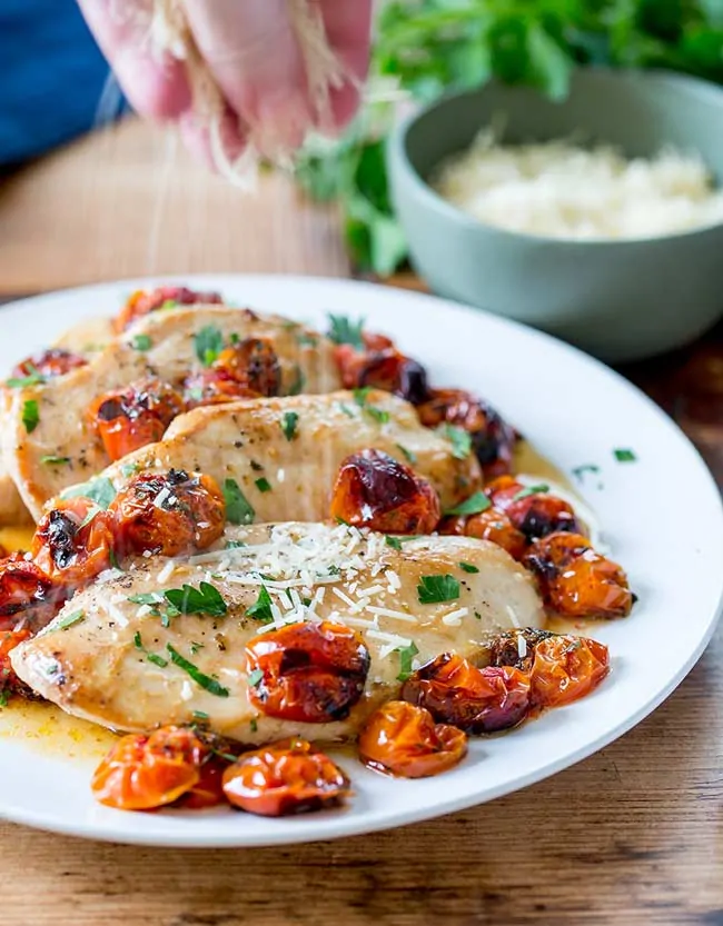 Sliced Baked Chicken with Cherry Tomatoes on a plate