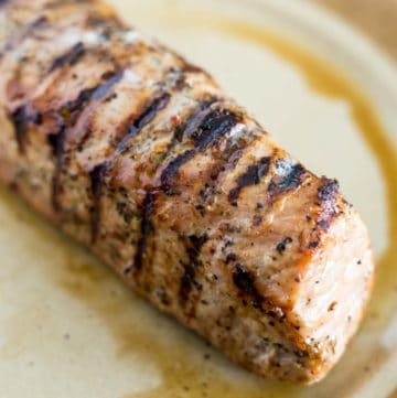 Grilled pork tenderloin resting on a plate