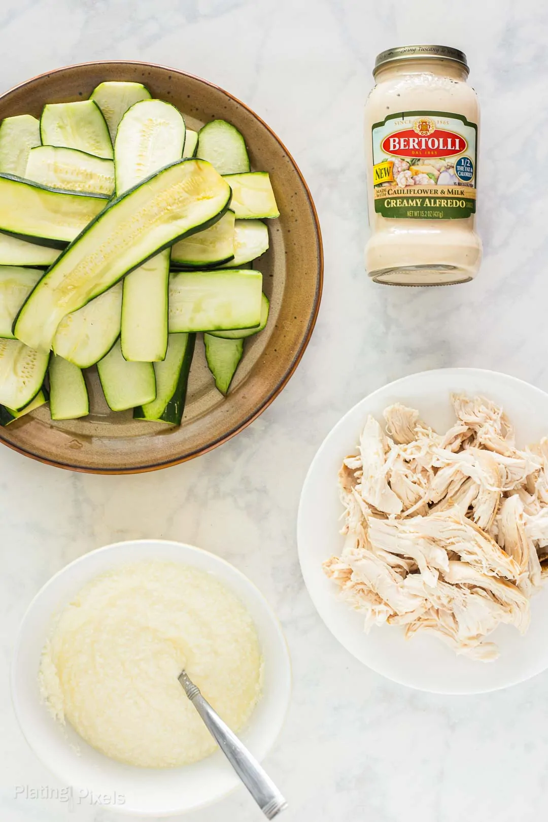 Overhead shot of prepared ingredients to make Chicken Alfredo Zucchini Lasagna