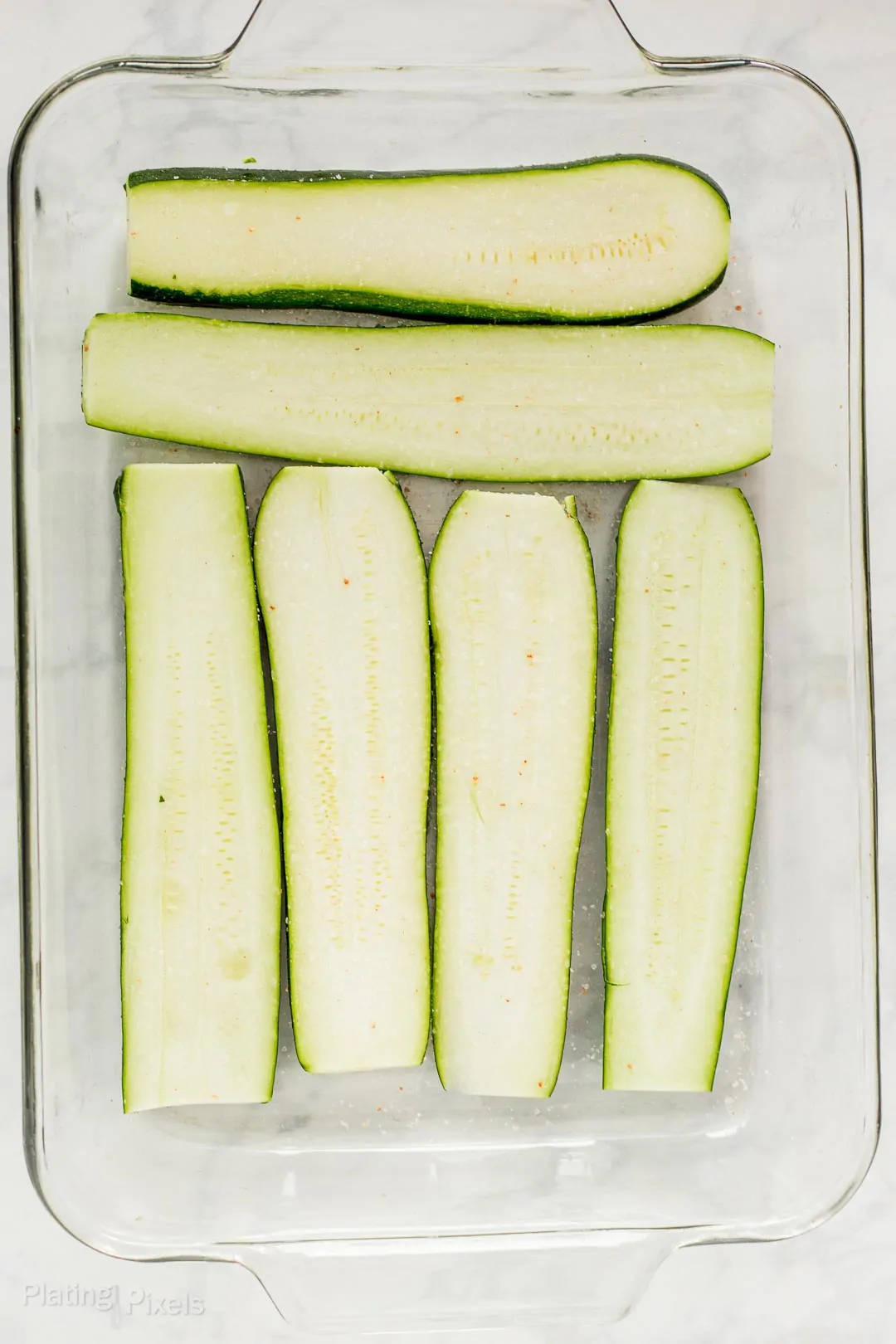 Layer of zucchini slices in a glass baking dish