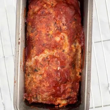 Just baked mushroom meatloaf in a bread pan cooling on a wire rack