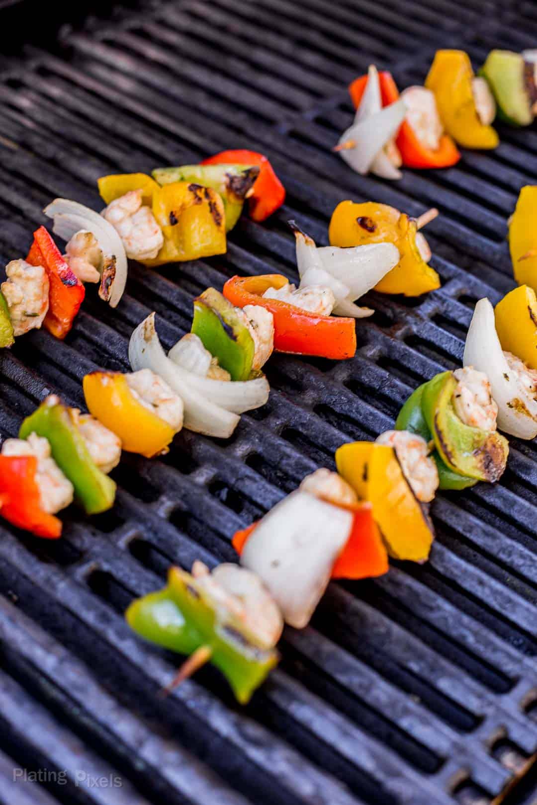 Shrimp Fajitas Skewers cooking on a gas grill