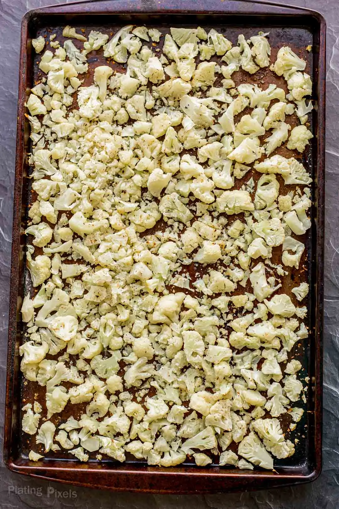 Roasted cauliflower pieces on a baking sheet
