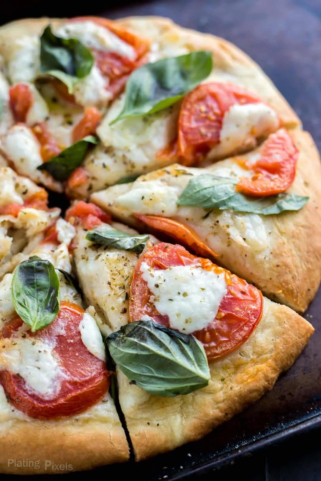 Close up of Caprese pizza cut into slices