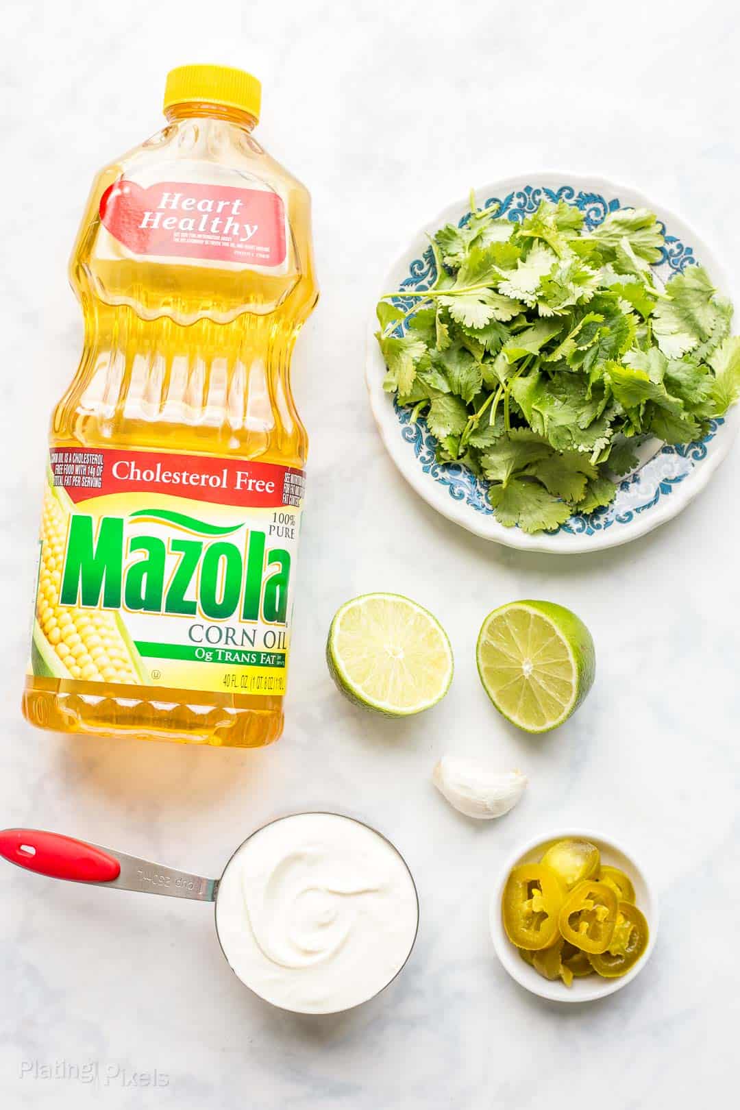 Ingredients to make homemade Cilantro Dressing on a marble countertop