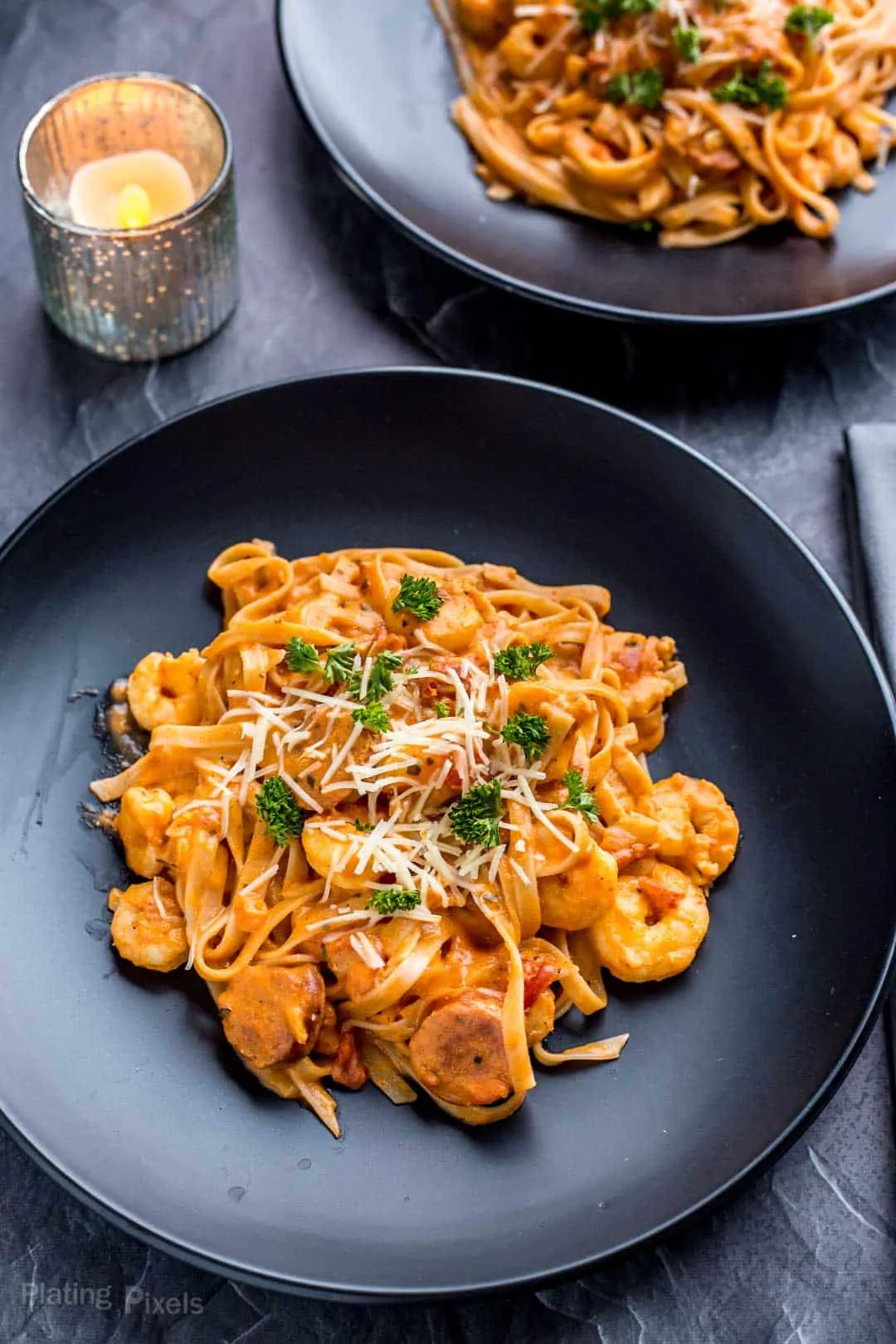 Two plates of Shrimp and Sausage Spaghetti with Rosa Sauce ready to eat