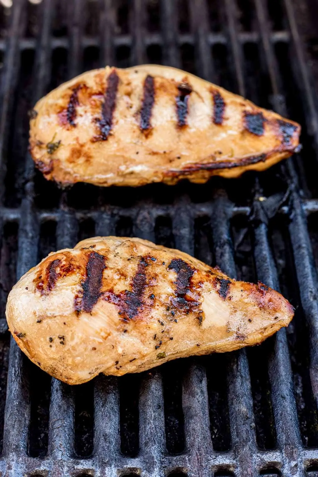 Process shot of grilling fajita marinated chicken breasts on a gas grill