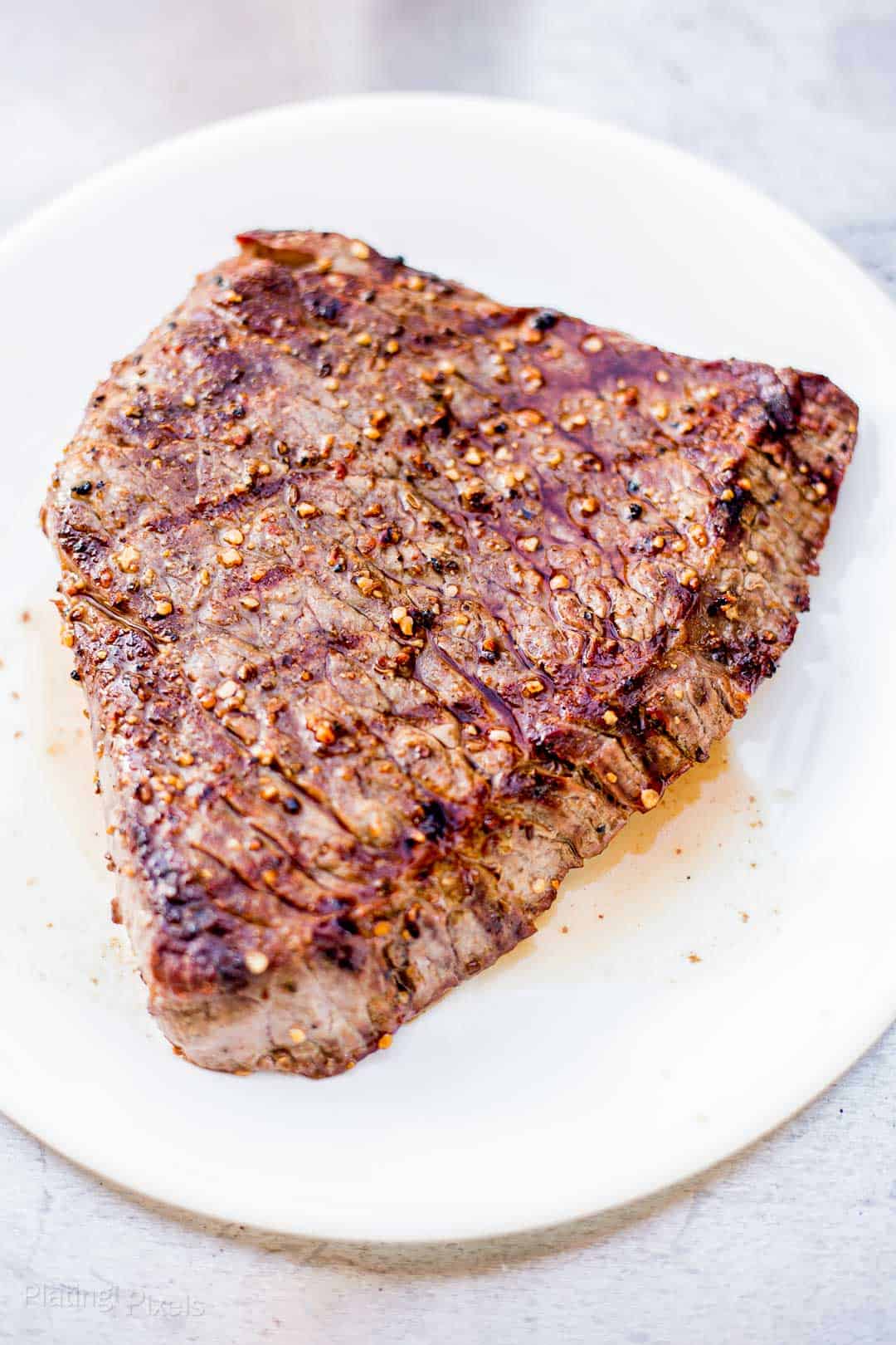 Grilled London Broil steak resting on a plate
