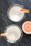 Overhead shot of two Grapefruit Martinis garnished with grapefruit wedges