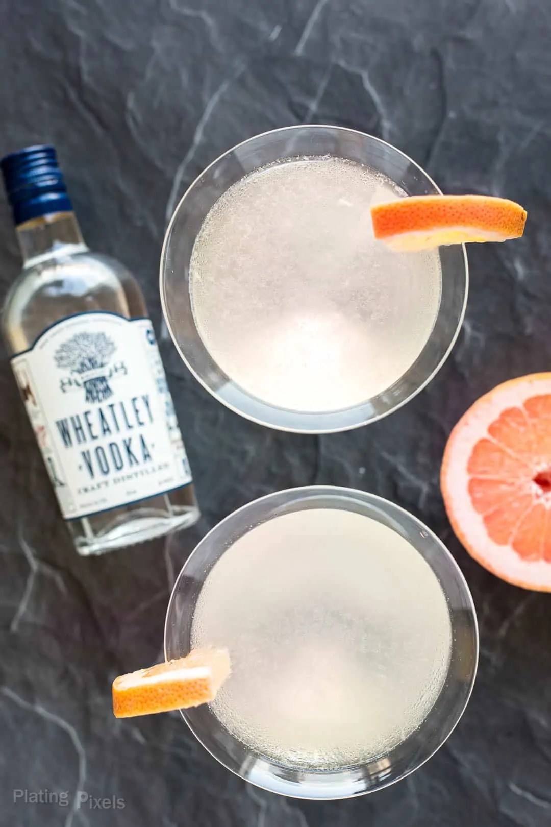 Overhead shot of Grapefruit Martinis next to a bottle of Wheatley Vodka