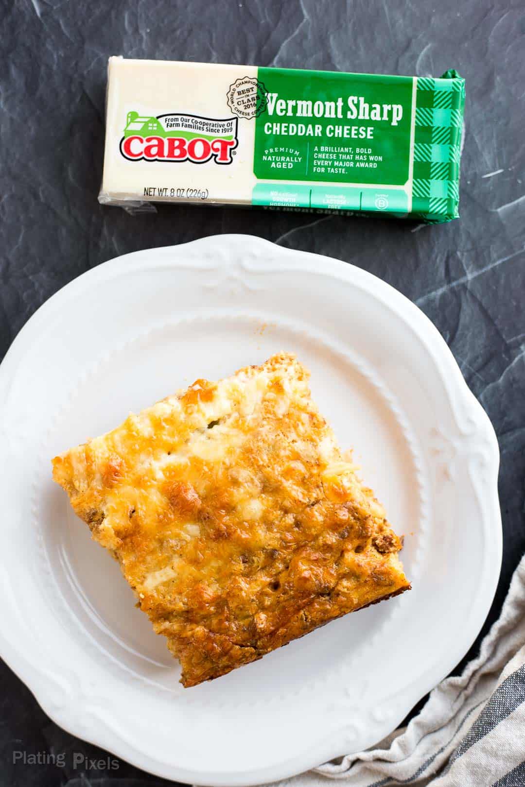Square of Hash Brown Breakfast Casserole next to block of Cabot cheddar cheese