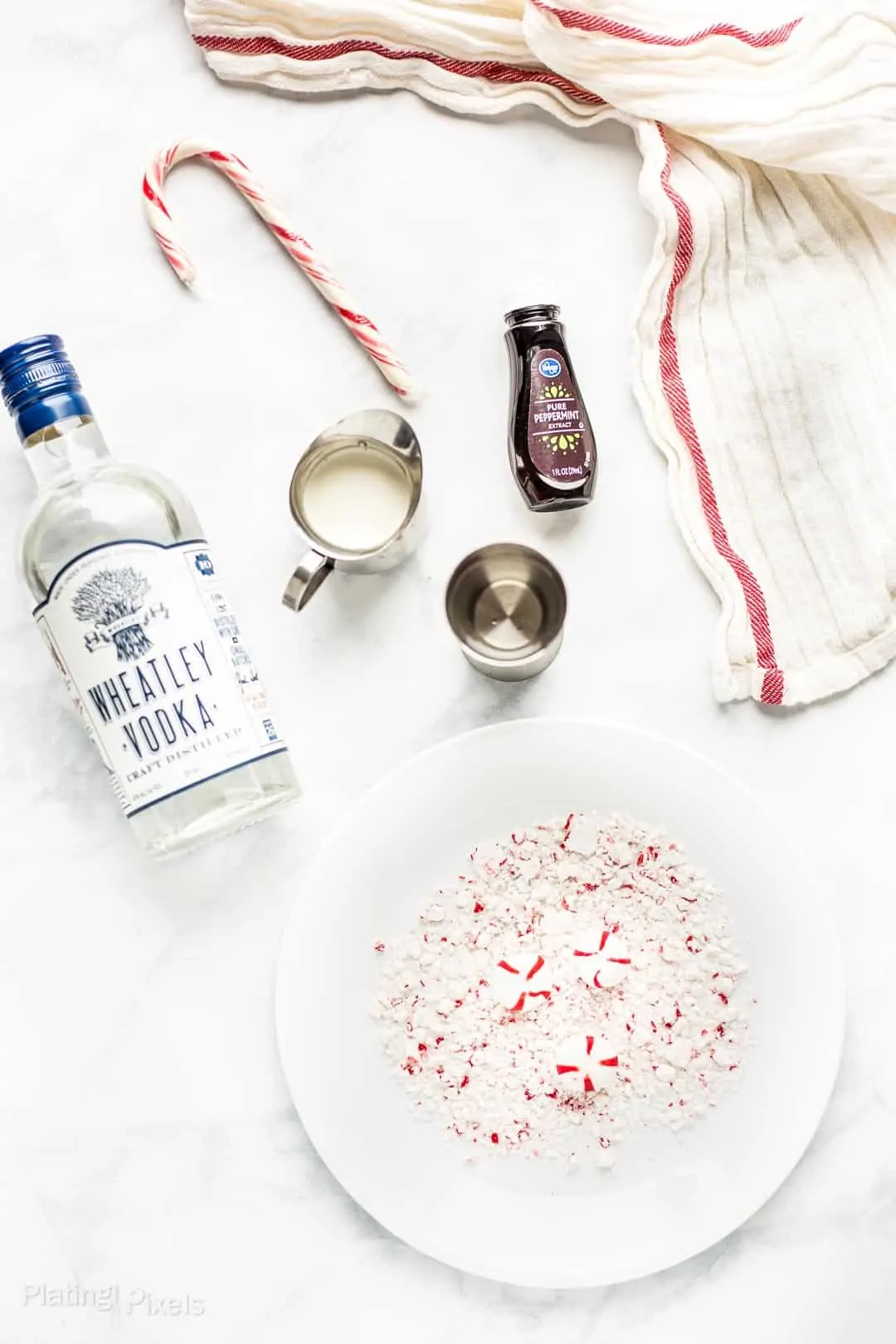 Ingredients to make a White Chocolate Peppermint Martini prepared on a counter