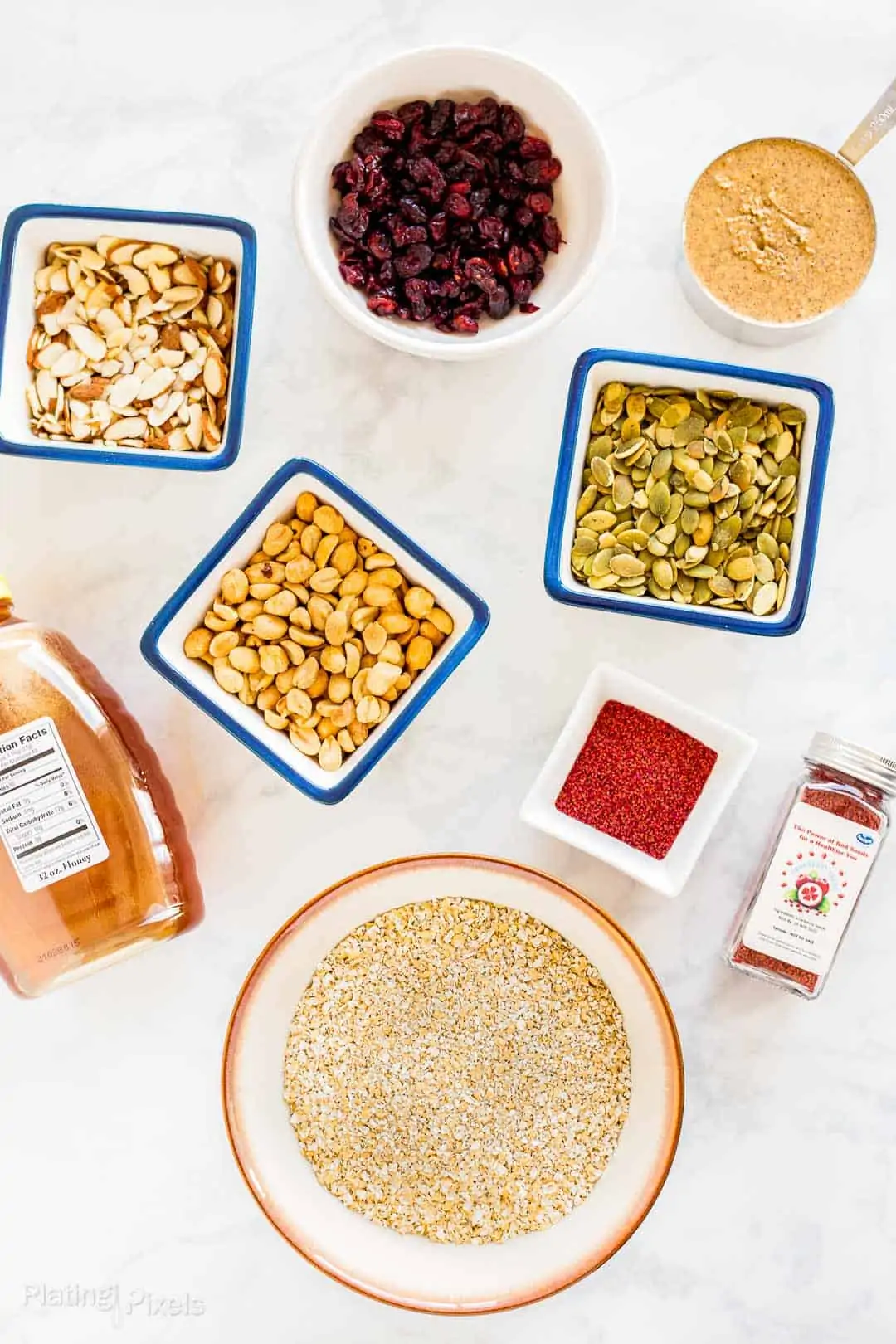 Ingredients for Cranberry Almond Granola Bars prepared on a counter