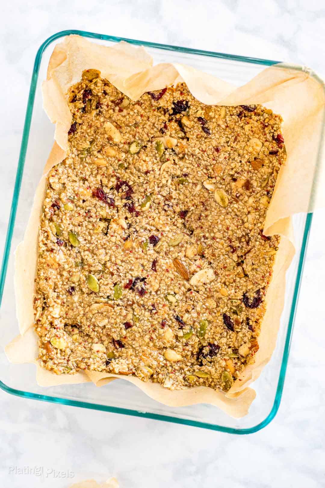 Cranberry Almond Granola Bars mixture pressed into a dish