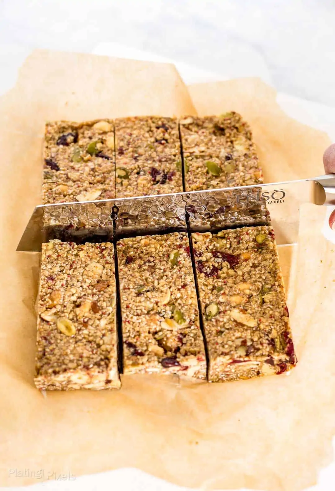 Using a knife to cut Cranberry Almond Granola Bars