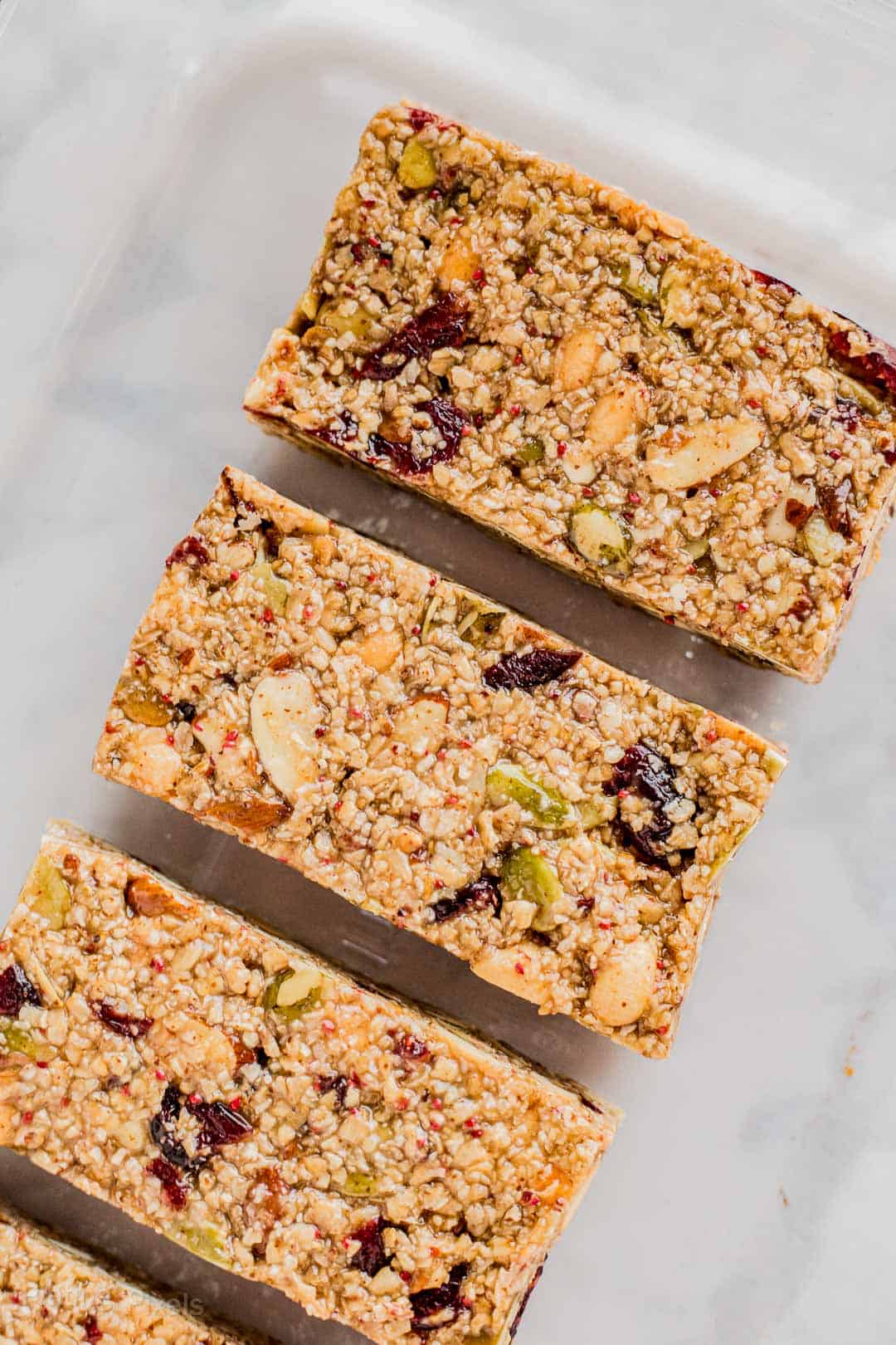 Cut Cranberry Almond Granola Bars on parchment paper