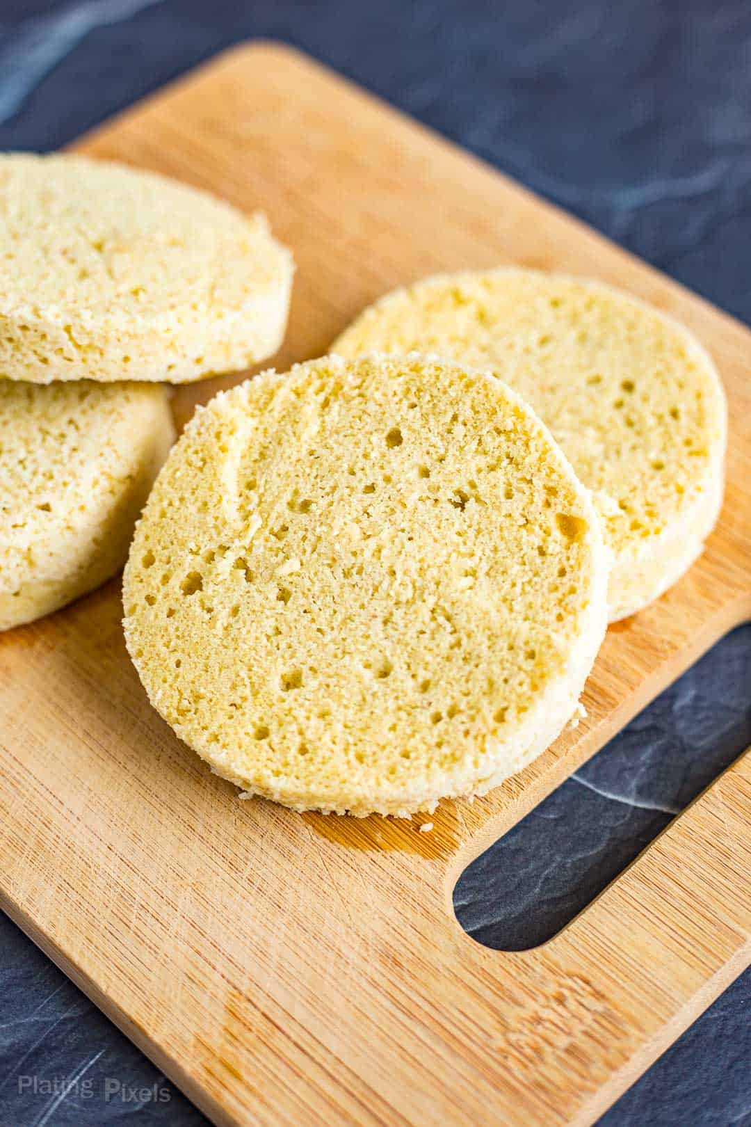 Keto English Muffin halves on a cutting board