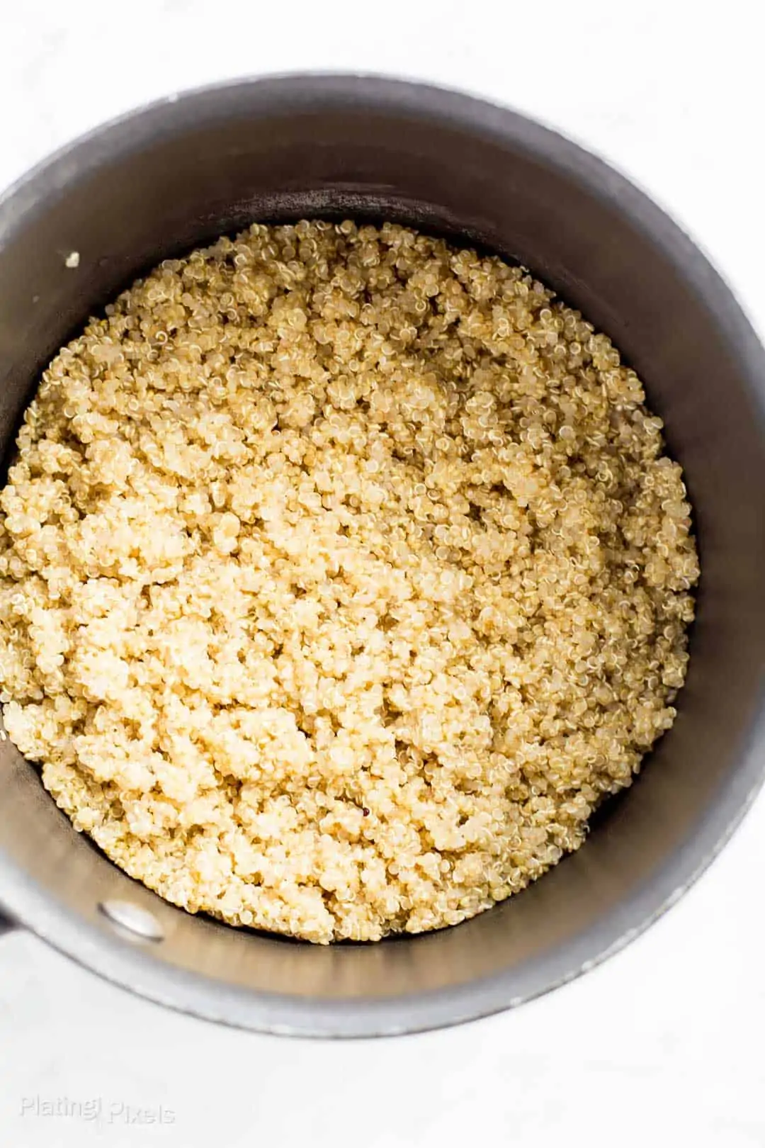 Process shot of cooking quinoa in a pan