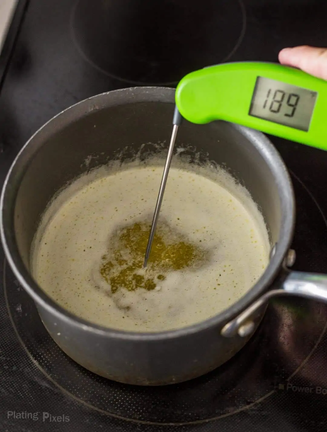 Using an instant-read thermometer to check temperature of melted butter