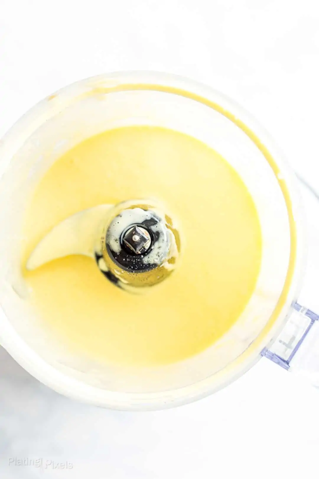 Overhead shot of easy Blender Hollandaise Sauce in a food processor