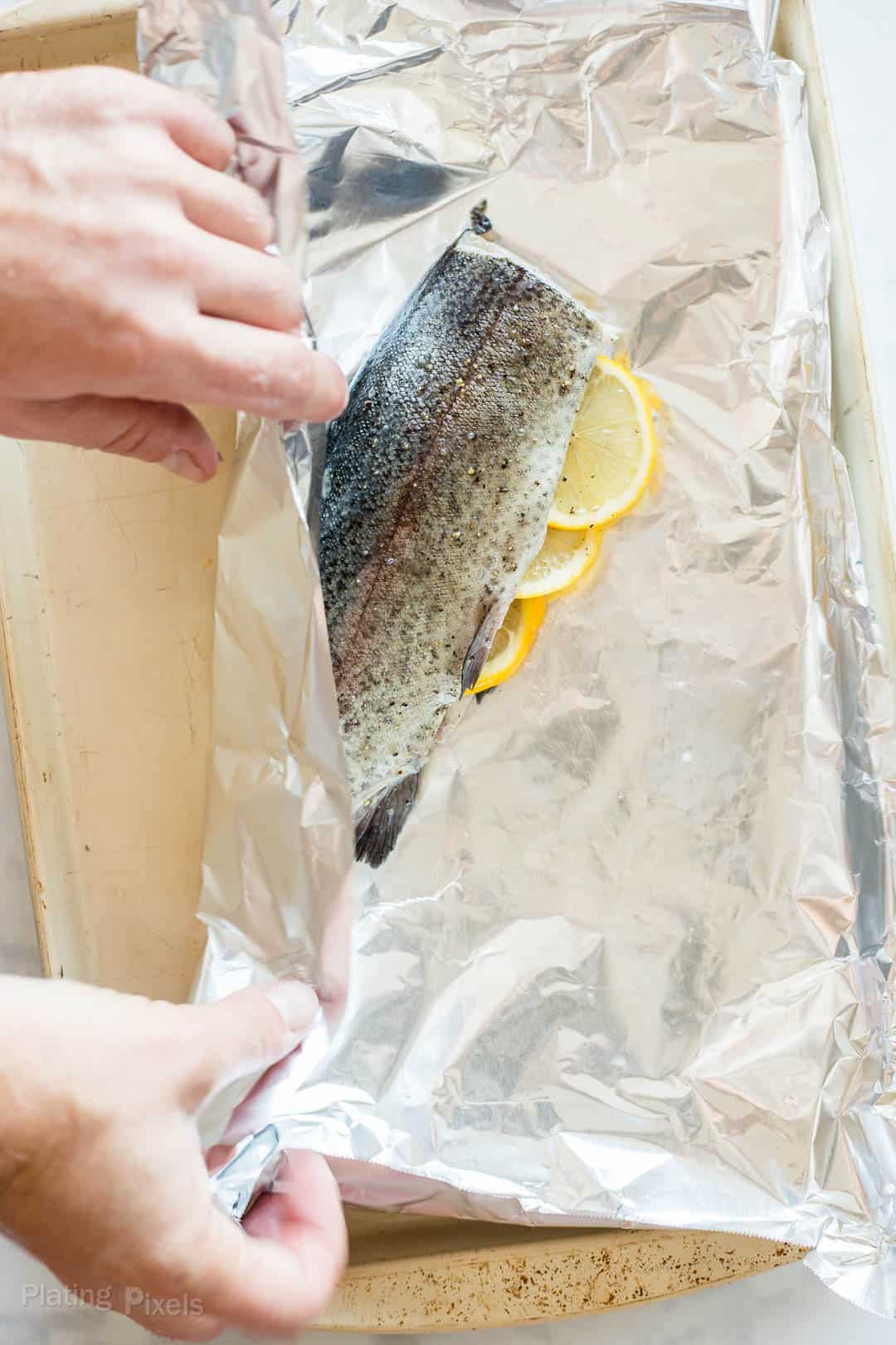 Process shot of starting to wrap a trout in foil