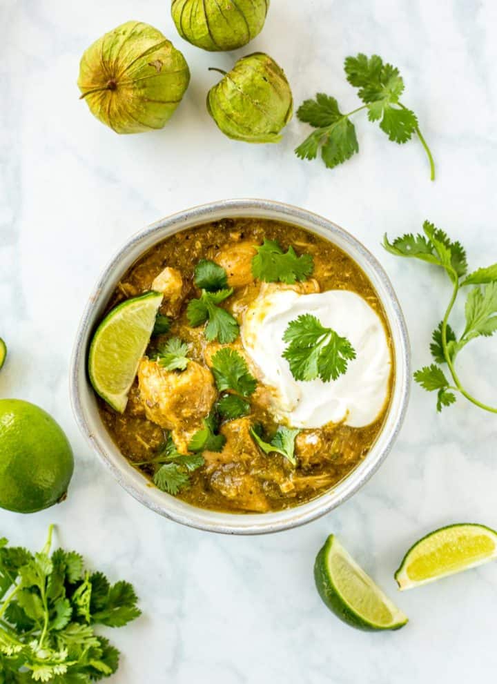 Chicken Chile Verde in a bowl with garnishes ready to eat