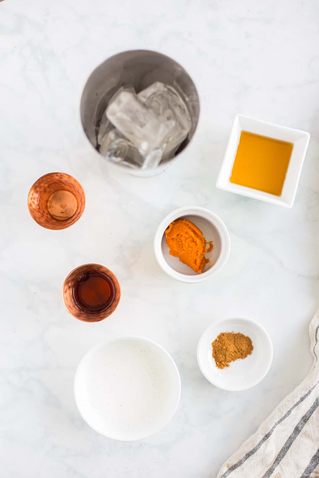 Ingredients to make Pumpkin Pie Martini prepared on a counter