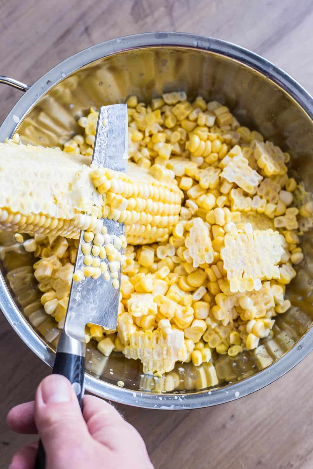Process shot of cutting corn kernels off the cob