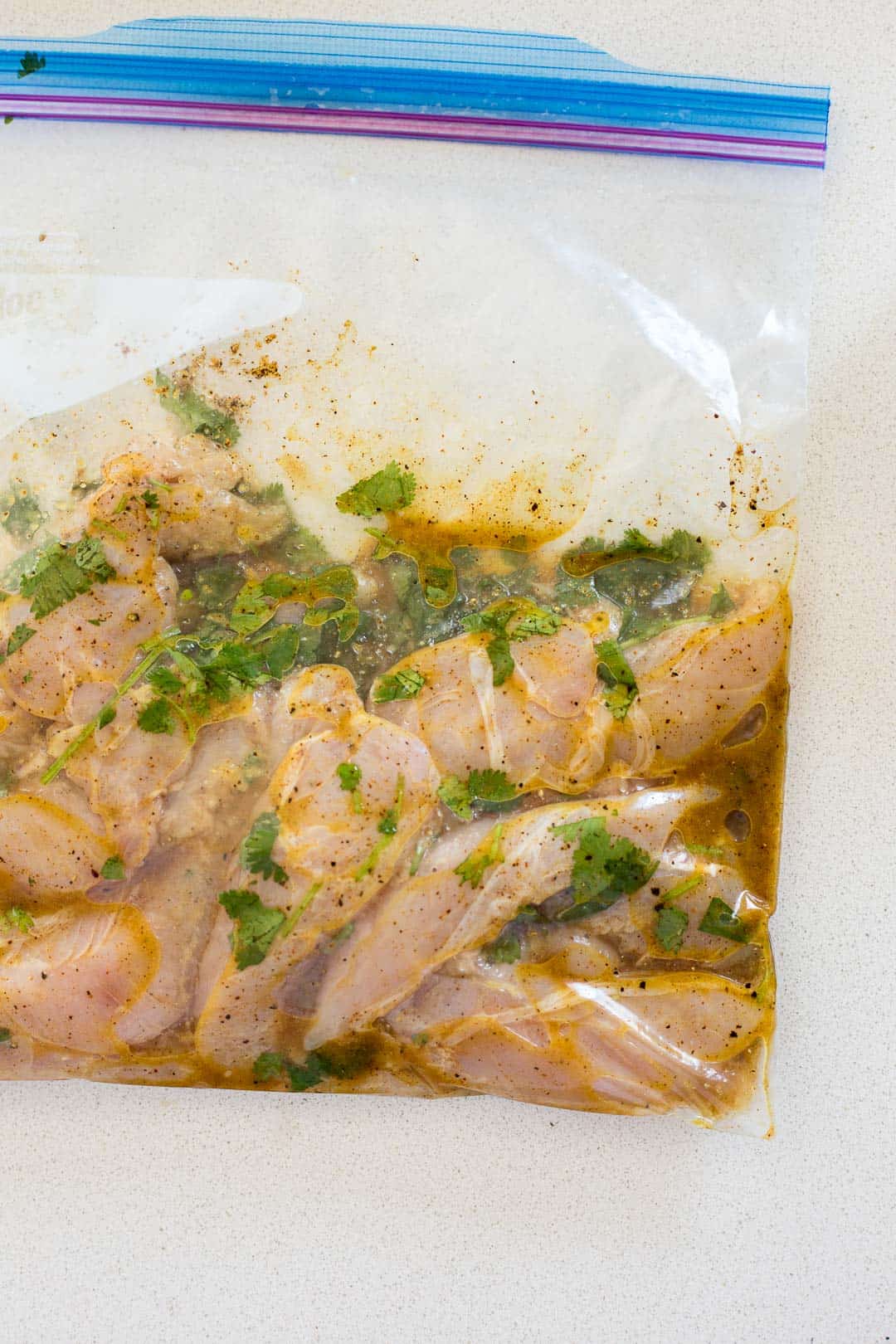 Chicken breast marinating in a bag