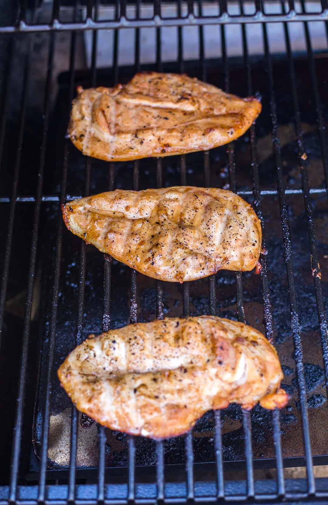 Teriyaki marinated chicken breasts cooking on the grill
