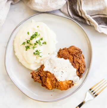 Overhead shot of Chicken Fried Chicken smothered with country gravy