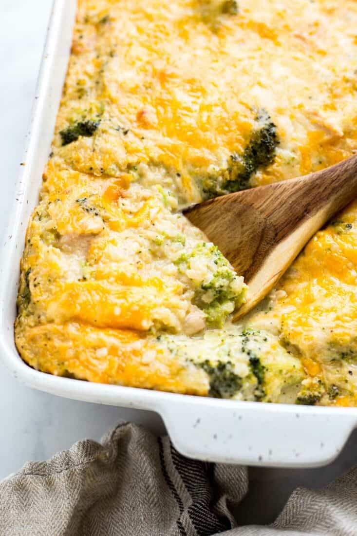 A wooden spoon scooping a serving of Keto Chicken Broccoli Casserole
