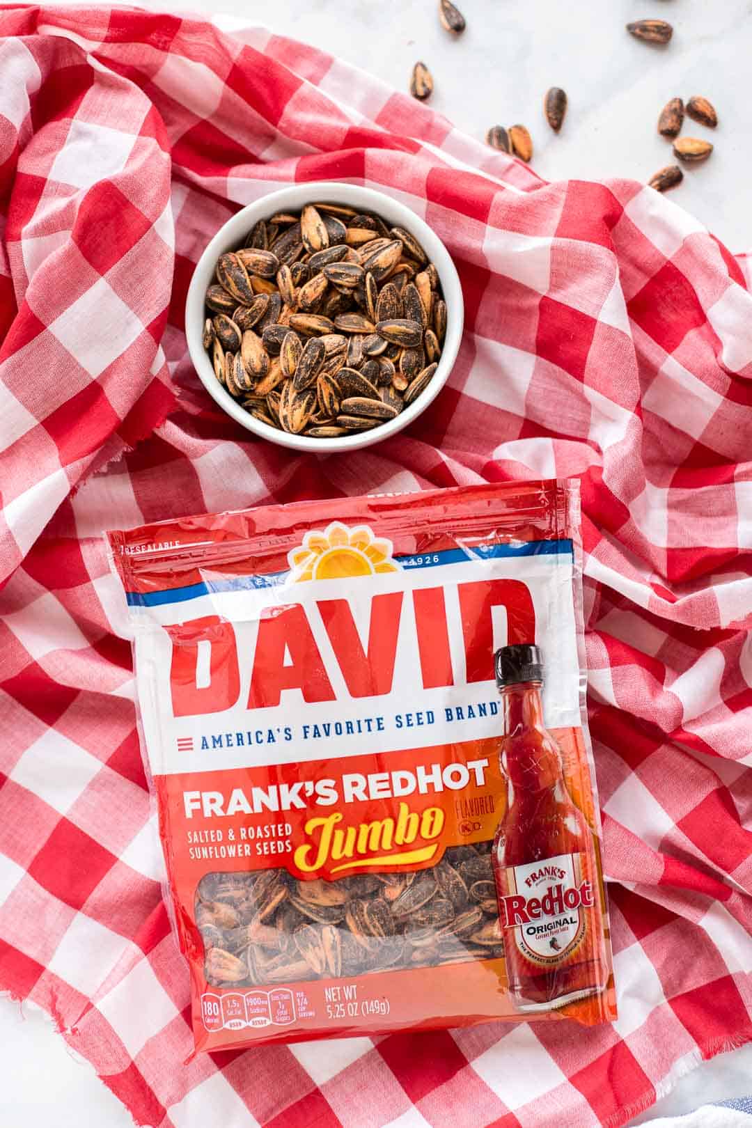 Bag of DAVID Frank’s RedHot Sunflower Seeds on a red and white background