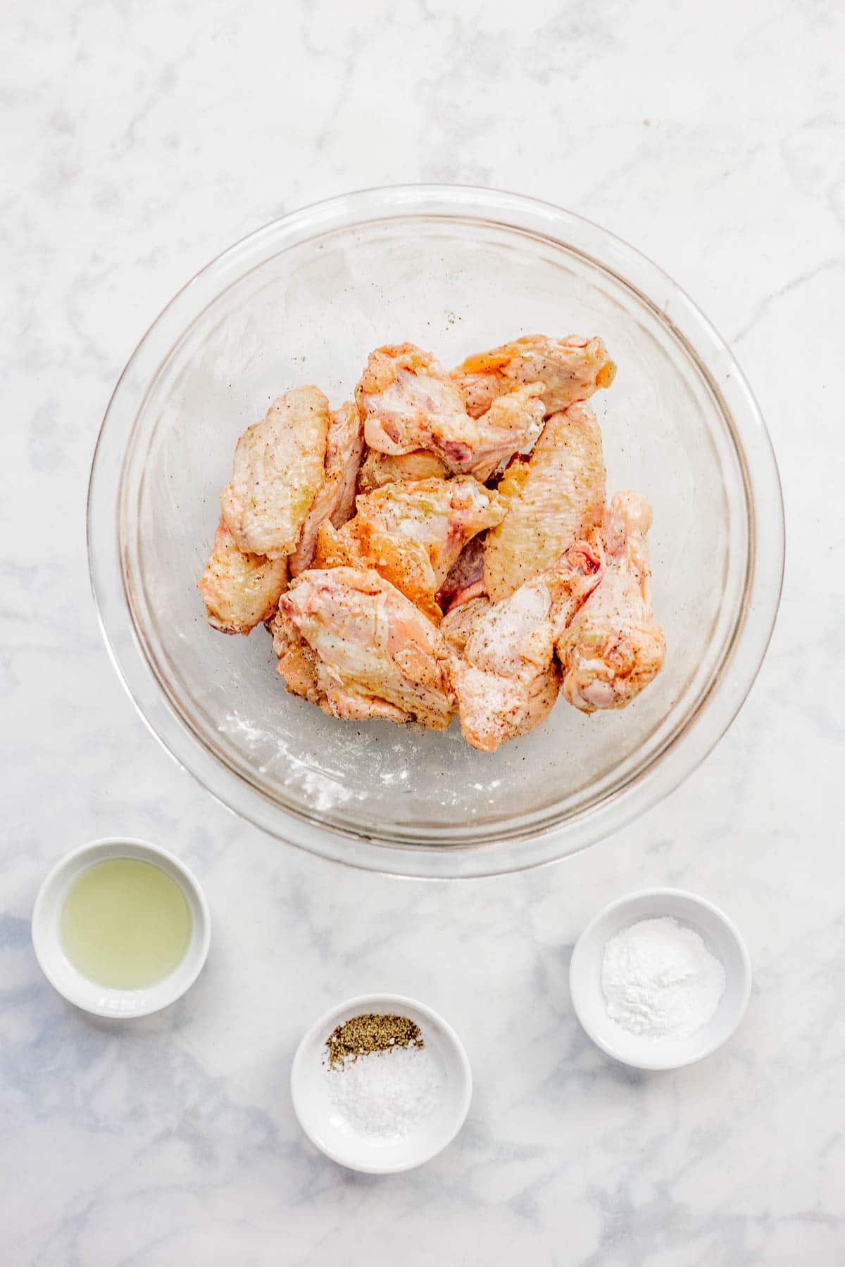 Prepared ingredients in bowls to make Air Fryer Chicken Wings