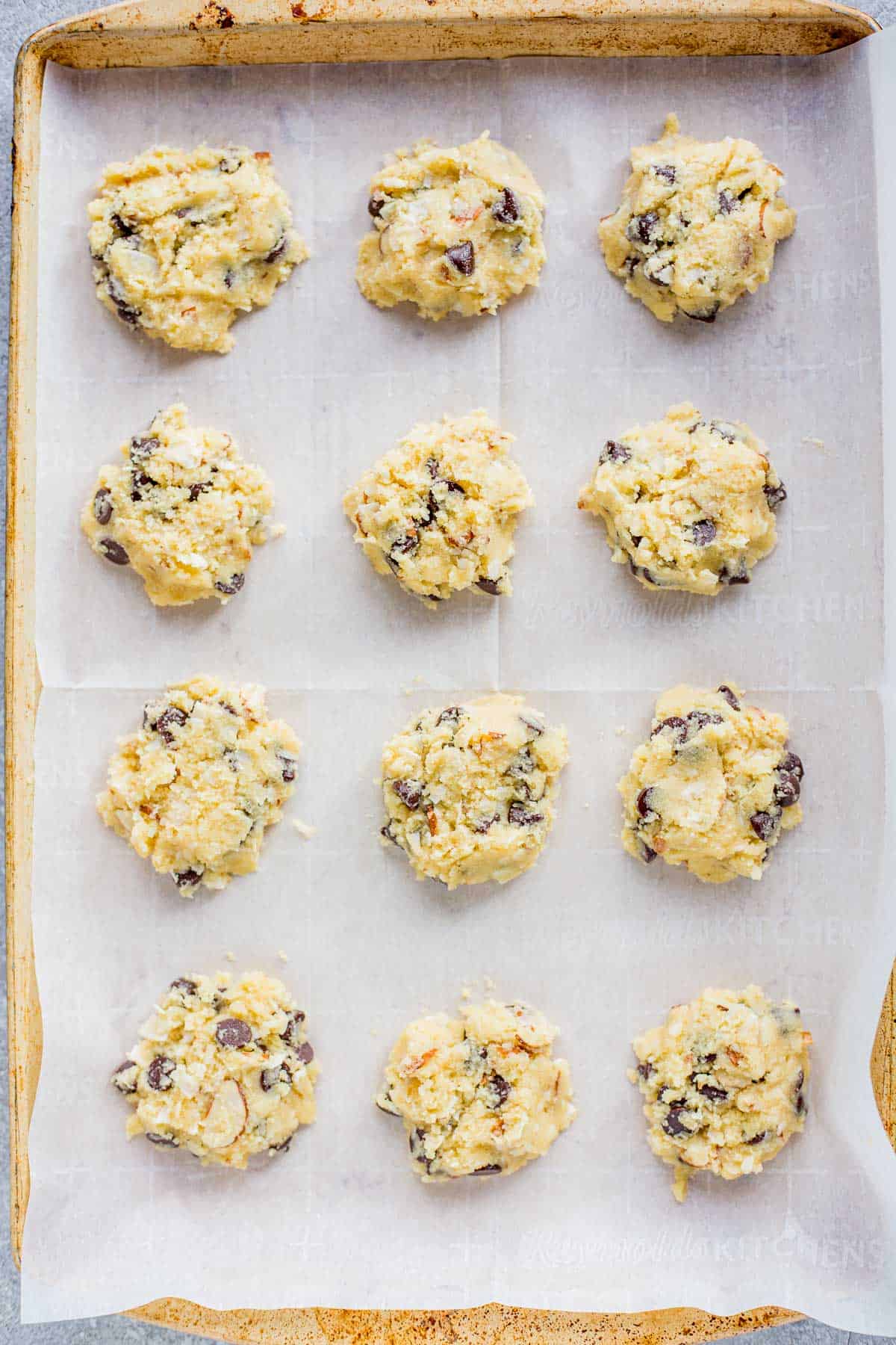 Keto Almond Joy Cookie mounds on a baking sheet