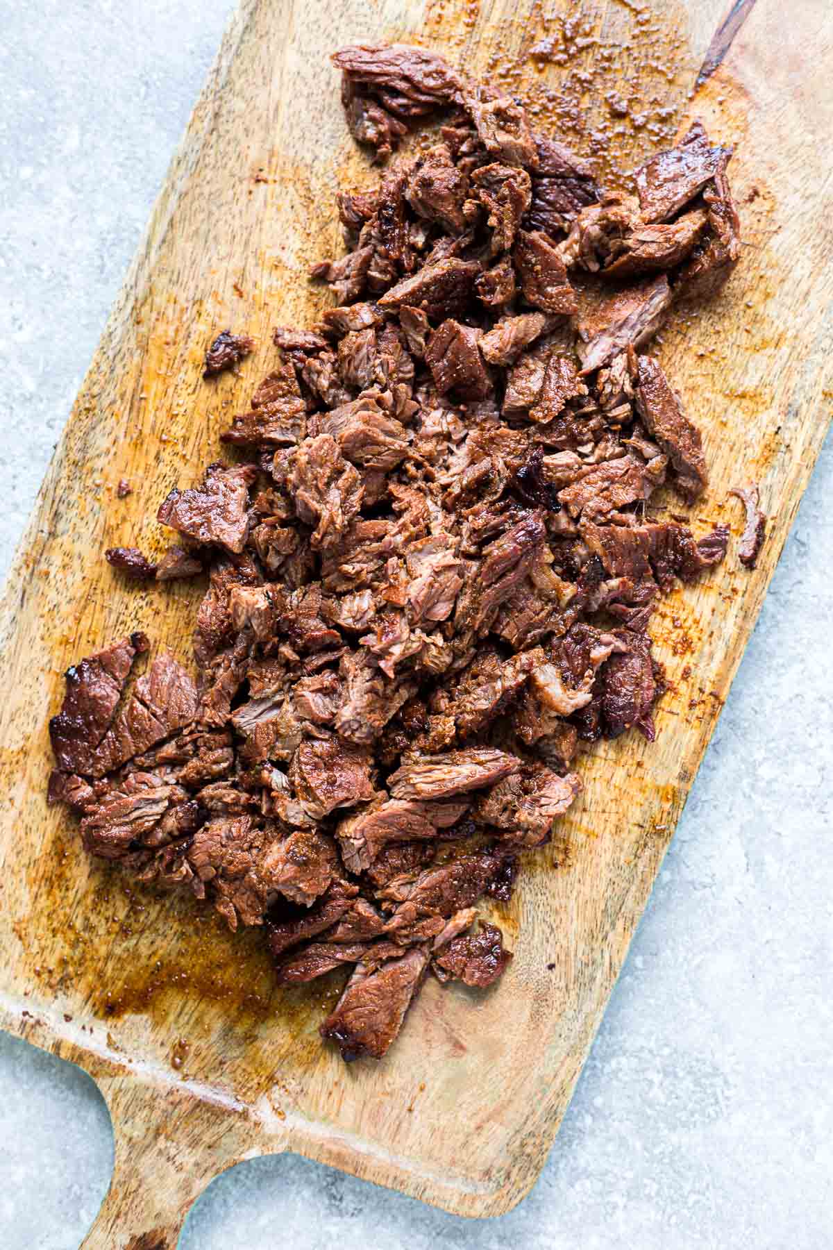 Chopped Carne Asada steak on a cutting board